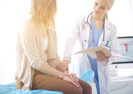 doctor with patient sitting on a hospital bed